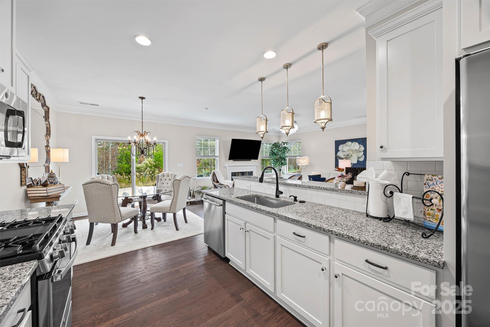 632 Amber Meadows Way Tega Cay, SC 29708 - Photo 15 of 48 a large kitchen with lots of counter space a sink appliances and living room view