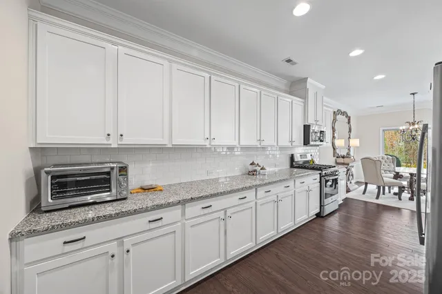 a kitchen with appliances a sink and cabinets