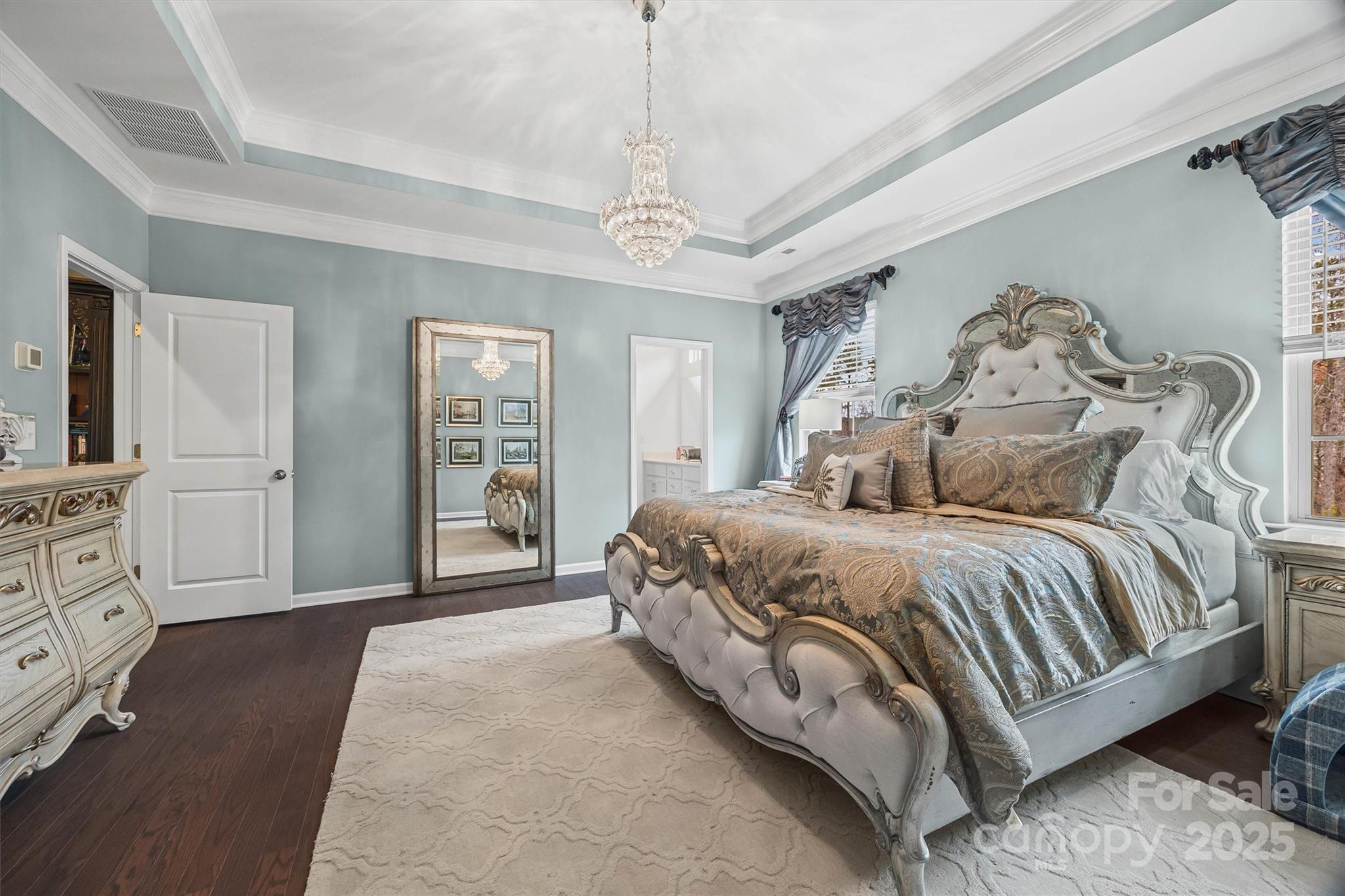 632 Amber Meadows Way Tega Cay, SC 29708 - Photo 22 of 48 a spacious bedroom with a large bed and a chandelier