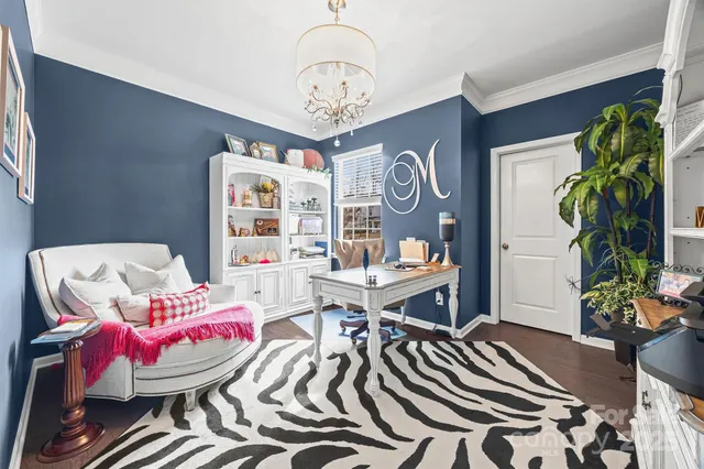 a living room with furniture and flowers