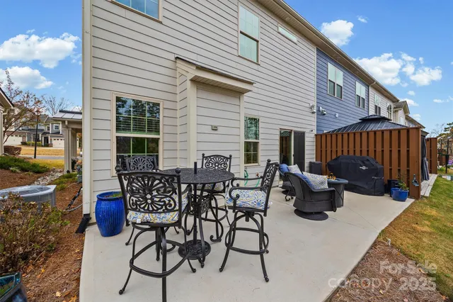 a view of backyard with a patio and outdoor seating