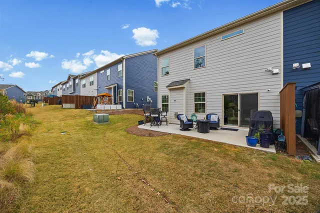 a view of a house with swimming pool patio and furniture