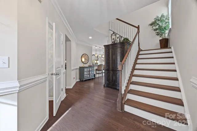 a view of entryway with stairs and wooden floor