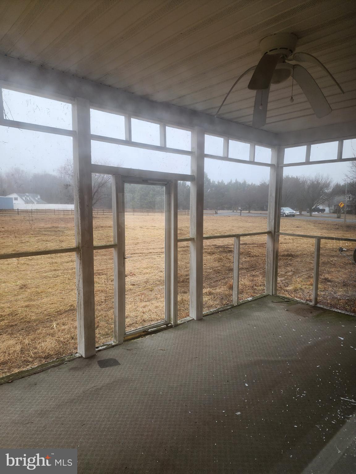 25331 Adams Landing Road Denton, MD 21629 - Photo 14 of 39 a view of an empty room with a floor to ceiling window and an outdoor view
