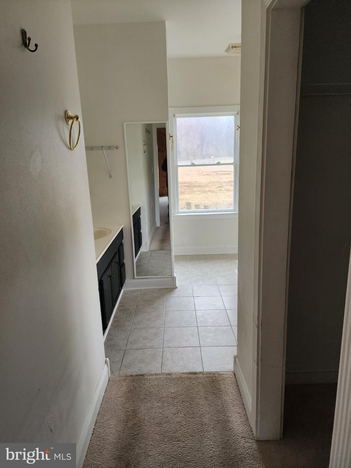 25331 Adams Landing Road Denton, MD 21629 - Photo 18 of 39 a view of a hallway to an empty room and a window