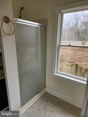 a bathroom with a glass shower door