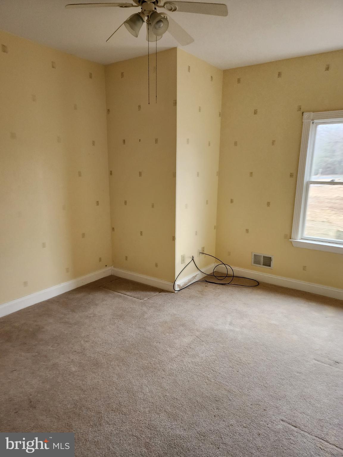25331 Adams Landing Road Denton, MD 21629 - Photo 22 of 39 an empty room with a ceiling fan and window