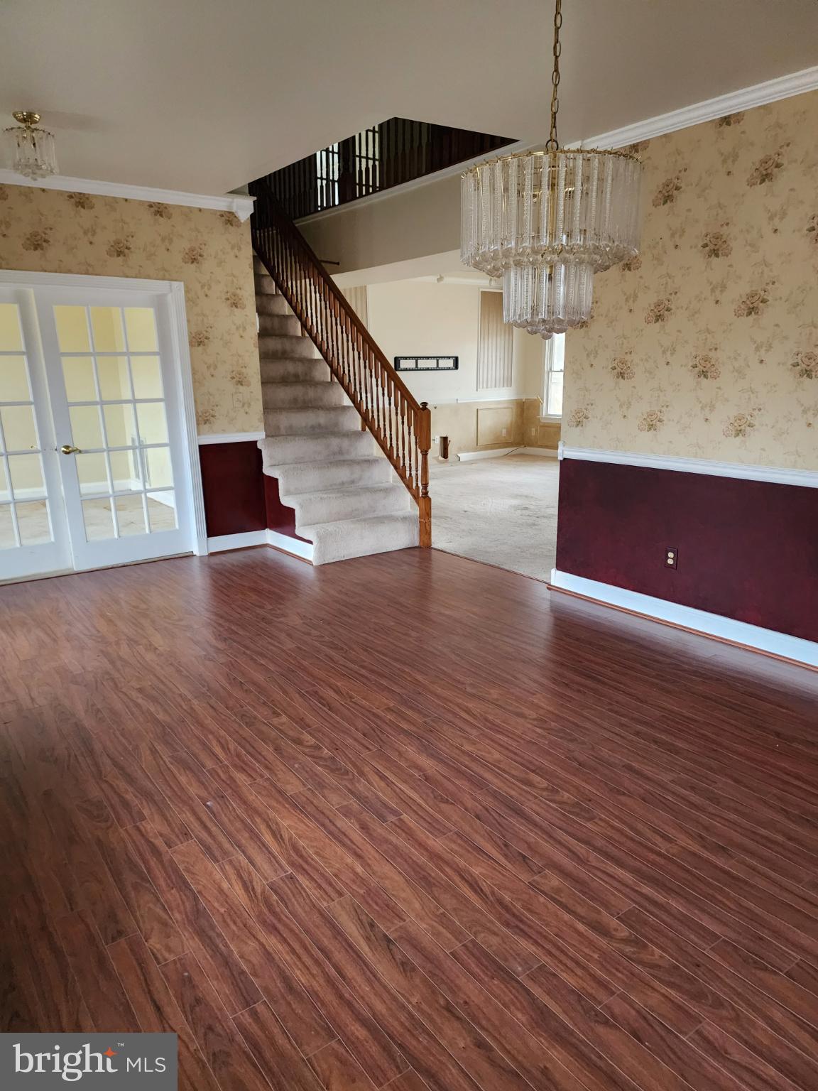 25331 Adams Landing Road Denton, MD 21629 - Photo 4 of 39 a view of an empty room with wooden floor and stairs