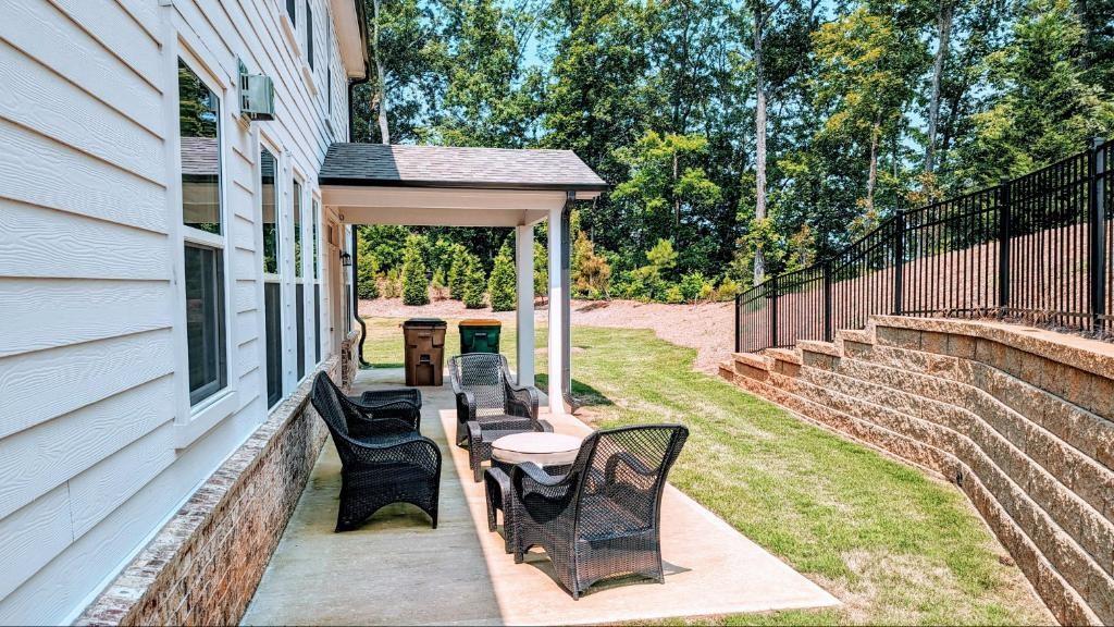 4830 Spangle Court Cumming, GA 30028 - Photo 3 of 18 a view of a patio with table and chairs potted plants with wooden floor and fence