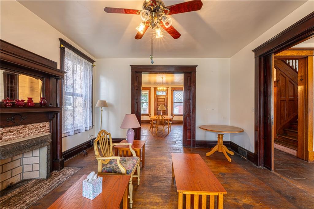 114 Union Street Uniontown, PA 15401 - Photo 5 of 28 a living room with furniture a fireplace and wooden floor
