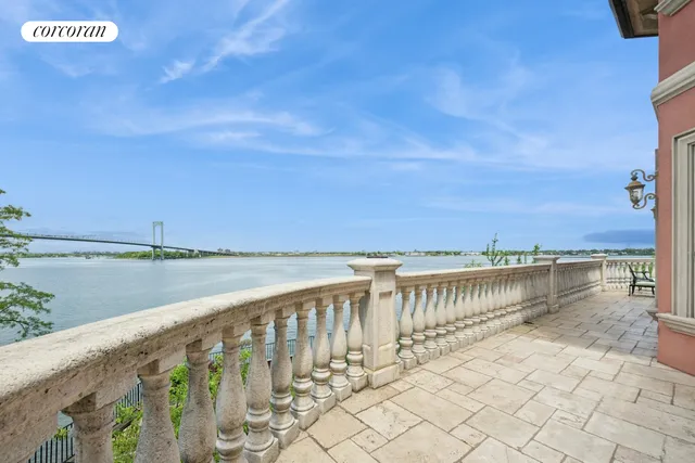 a view of a chairs and table in patio with a yard
