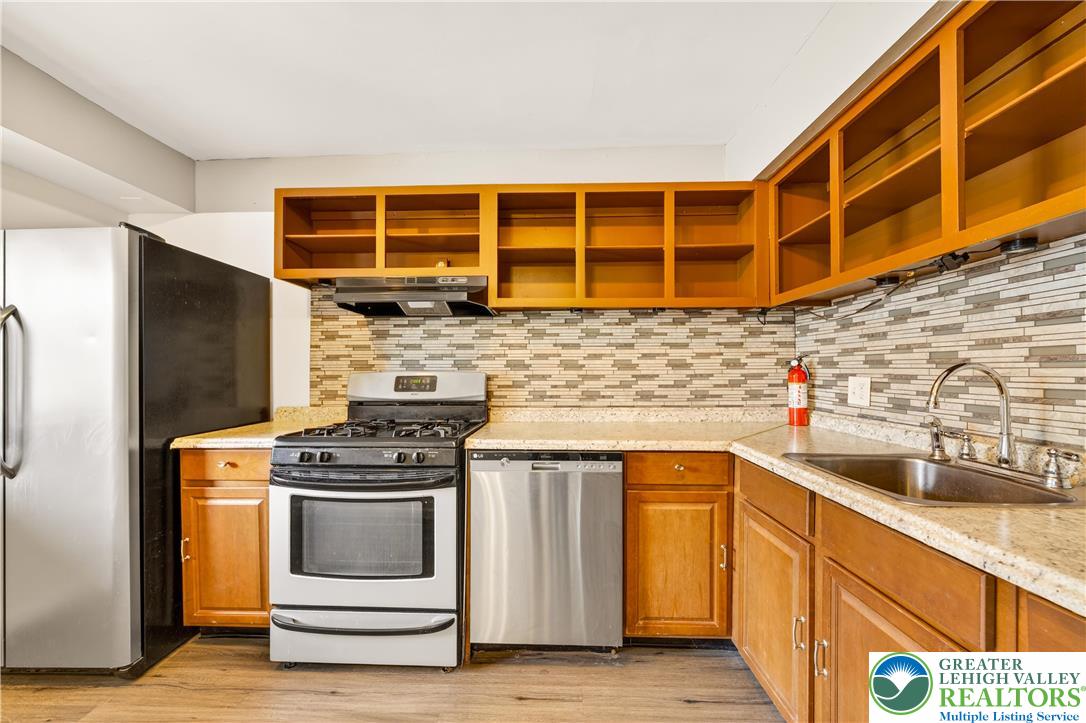 1575 Creekside Road, Unit A2 Whitehall, PA 18052 - Photo 11 of 26 a kitchen with stainless steel appliances a stove and a refrigerator