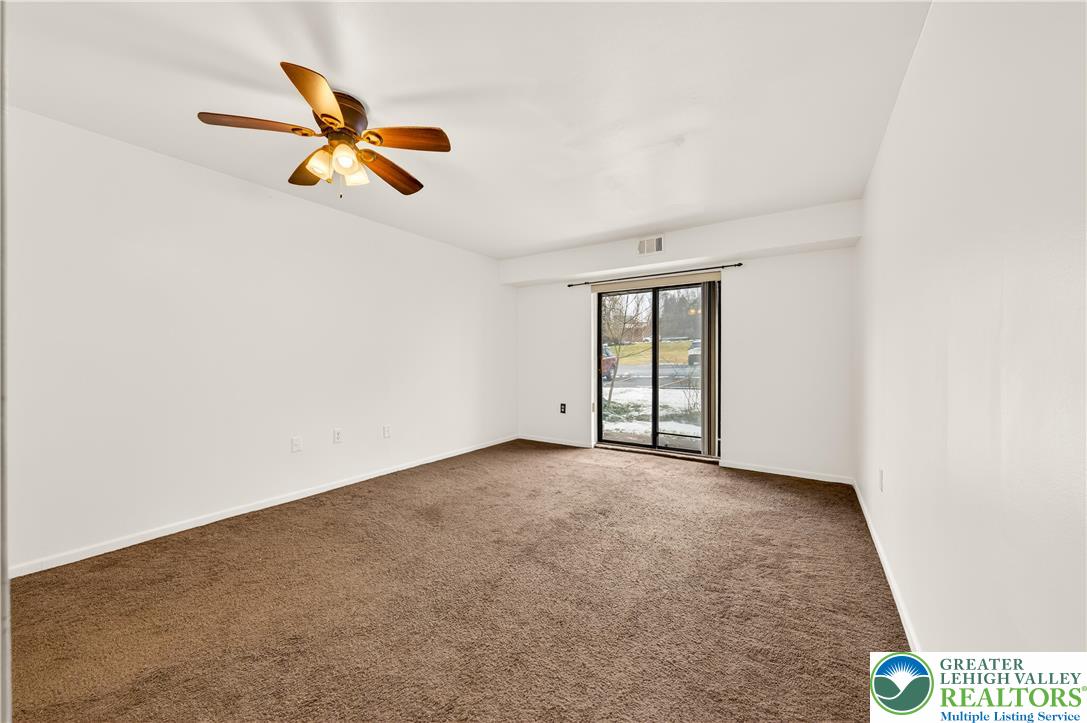 1575 Creekside Road, Unit A2 Whitehall, PA 18052 - Photo 18 of 26 an empty room with windows and fan