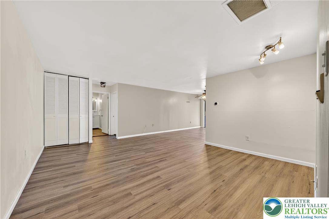 1575 Creekside Road, Unit A2 Whitehall, PA 18052 - Photo 5 of 26 an empty room with wooden floor and windows