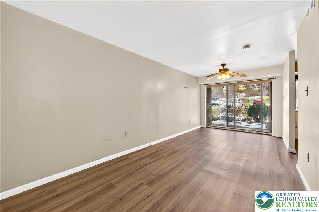 1575 Creekside Road, Unit A2 Whitehall, PA 18052 - Photo 6 of 26 wooden floor in an empty room with a window