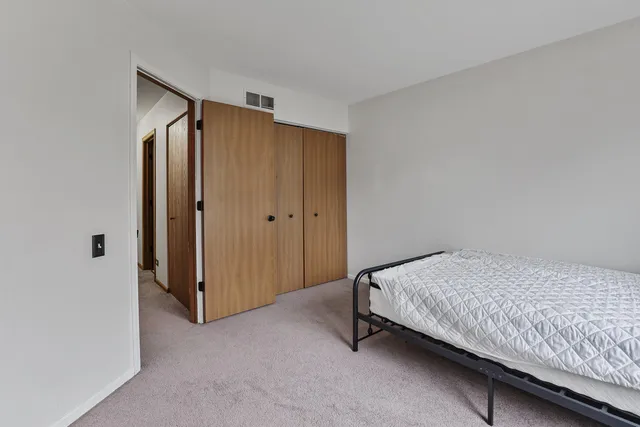 a bedroom with a bed and a closet