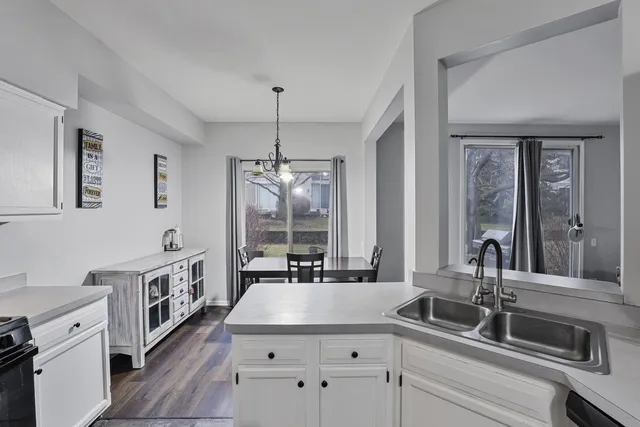 a kitchen with stainless steel appliances a sink stove and cabinets