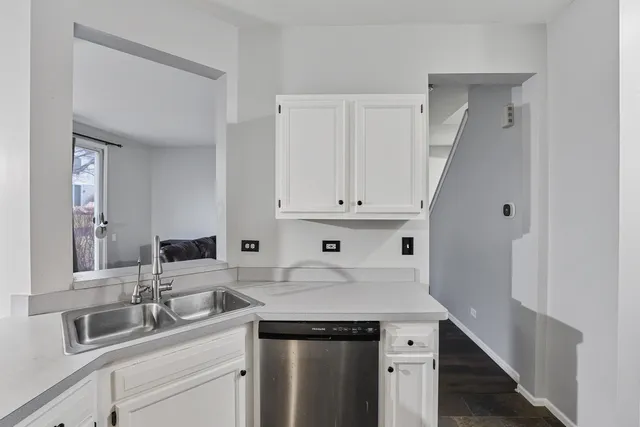 a kitchen with a sink and cabinets
