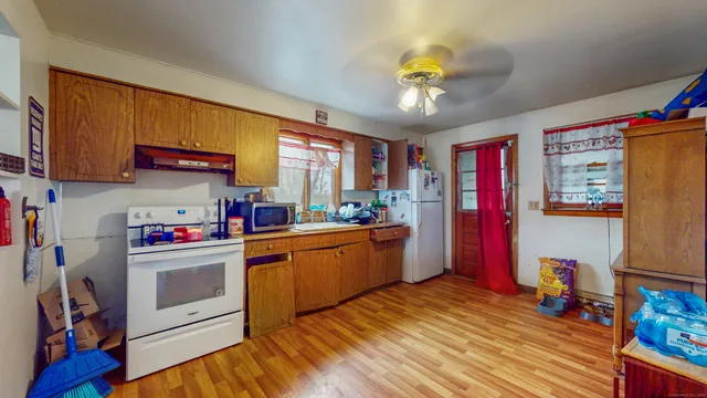 a kitchen with stainless steel appliances granite countertop a refrigerator and a stove top oven