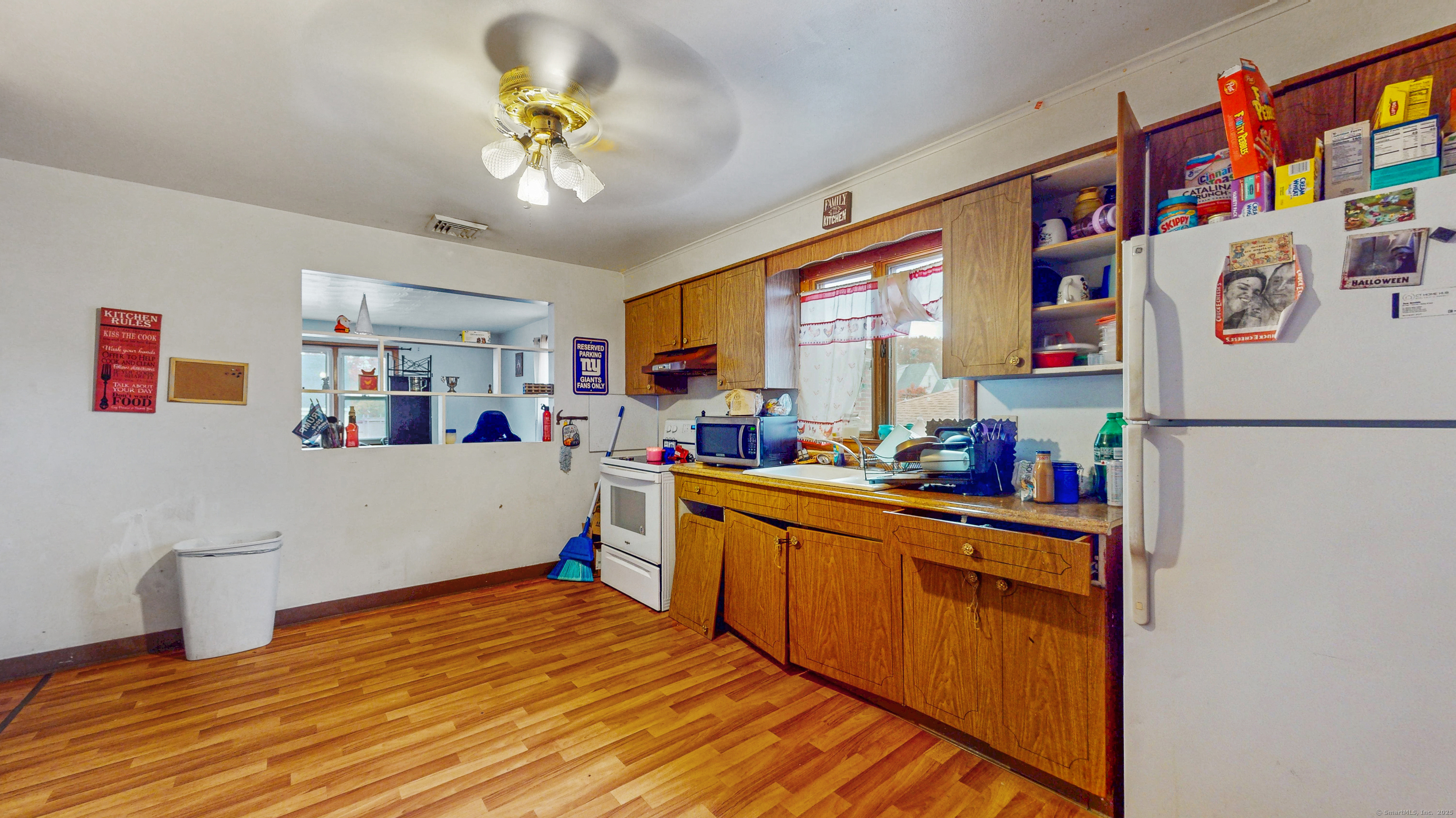 62 Rosemount Avenue Waterbury, CT 06708 - Photo 6 of 20 a kitchen with stainless steel appliances granite countertop a refrigerator a sink dishwasher a dining table and chairs with wooden floor