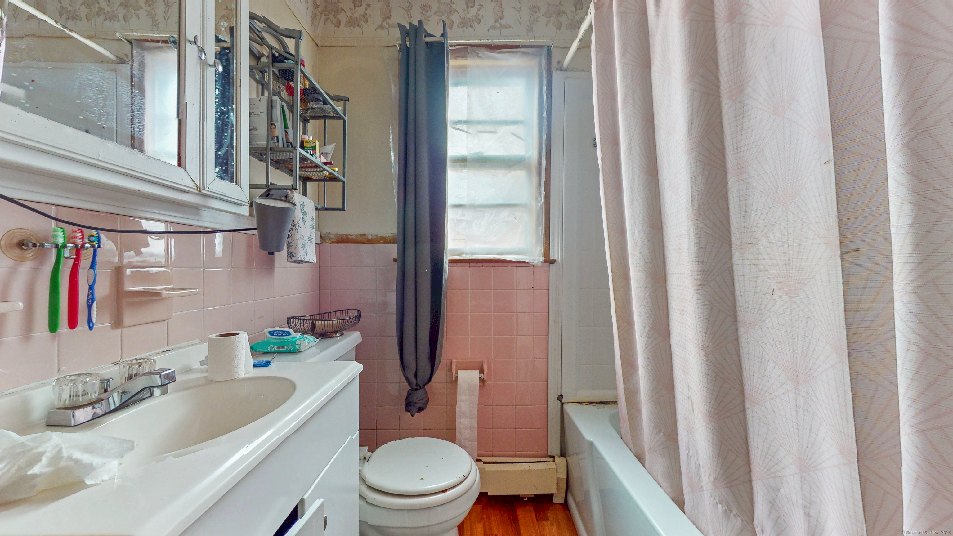62 Rosemount Avenue Waterbury, CT 06708 - Photo 9 of 20 a bathroom with a sink a toilet a mirror and shower