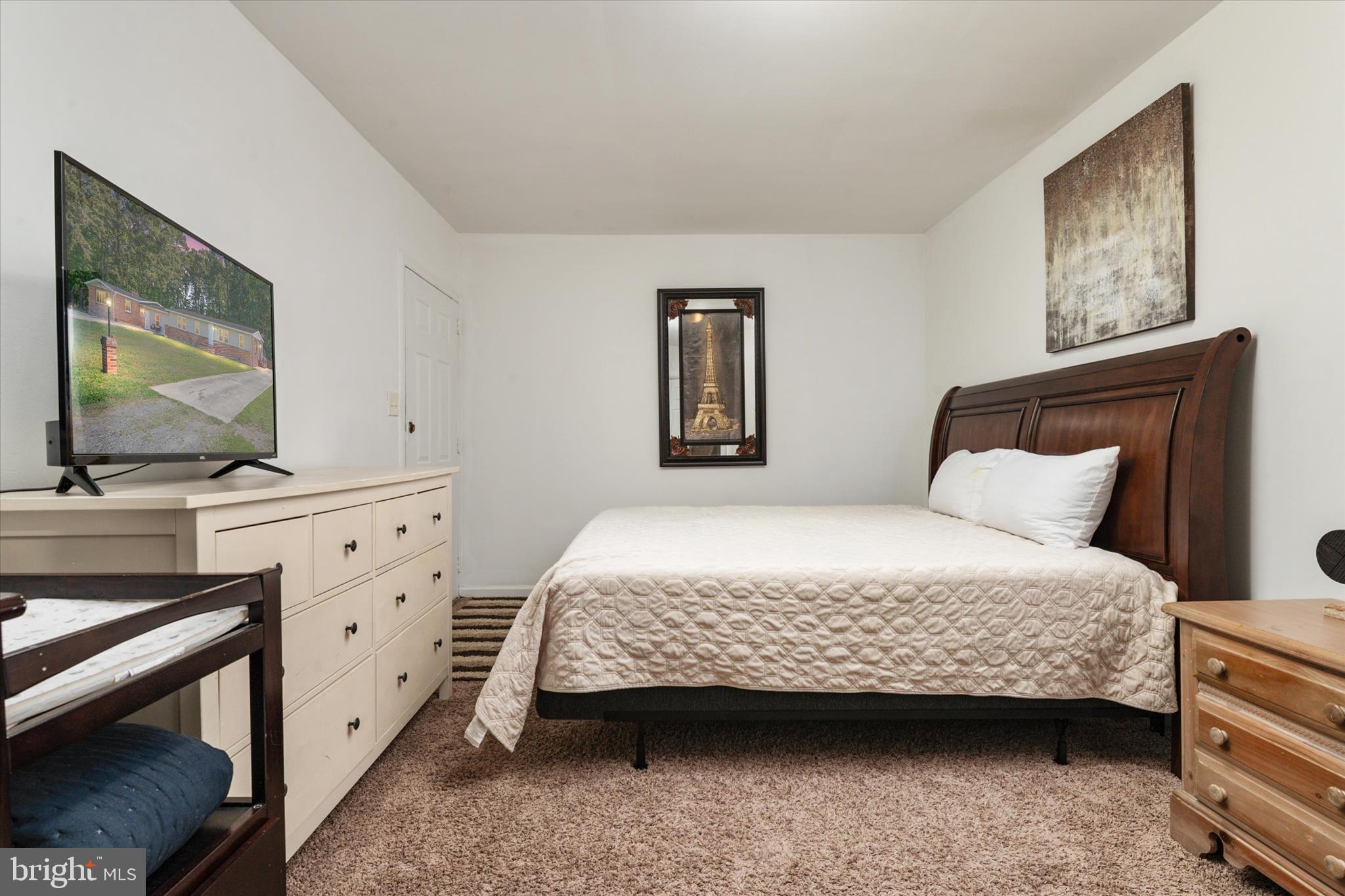 108 Wilson Road Grasonville, MD 21658 - Photo 25 of 38 a bedroom with a bed and a flat screen tv