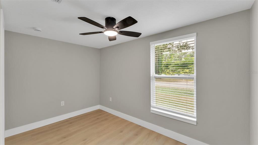2211 Azalea Court Lakeland, FL 33815 - Photo 12 of 22 an empty room with windows and fan