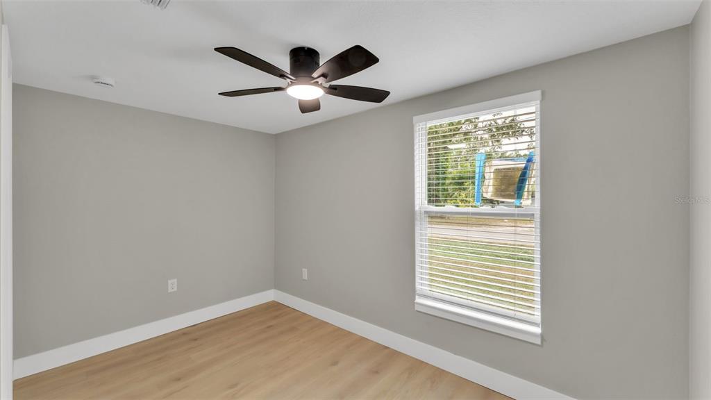 2211 Azalea Court Lakeland, FL 33815 - Photo 13 of 22 an empty room with windows and fan