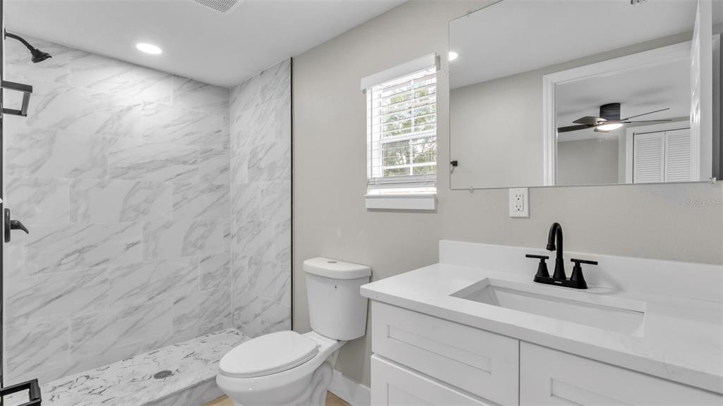 2211 Azalea Court Lakeland, FL 33815 - Photo 17 of 22 a bathroom with a sink a toilet and shower