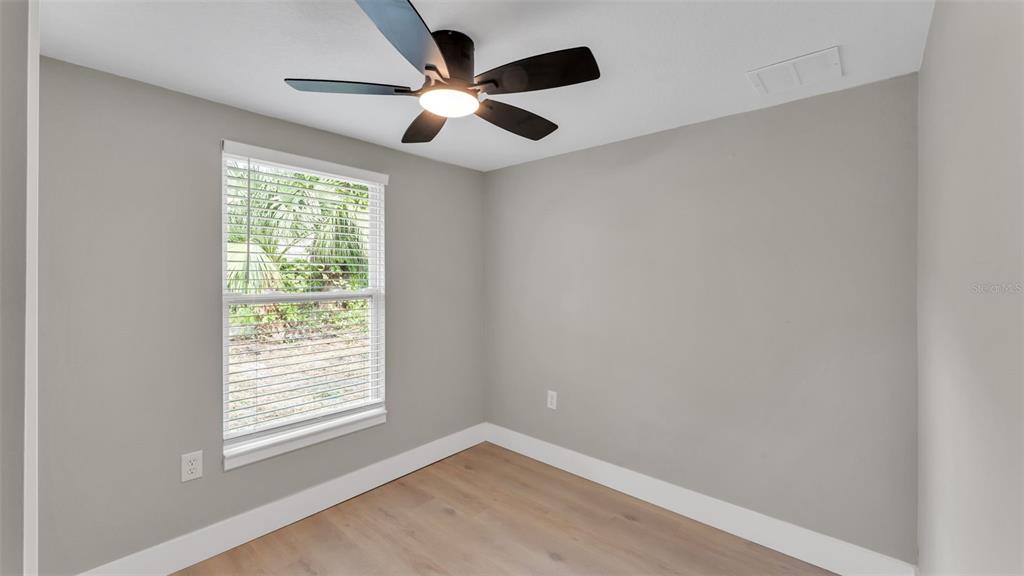 2211 Azalea Court Lakeland, FL 33815 - Photo 19 of 22 an empty room with ceiling fan and windows