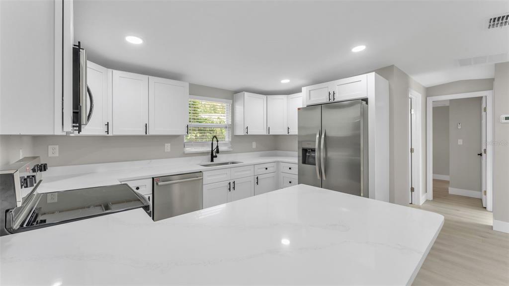 2211 Azalea Court Lakeland, FL 33815 - Photo 10 of 22 a kitchen with a sink a refrigerator and window