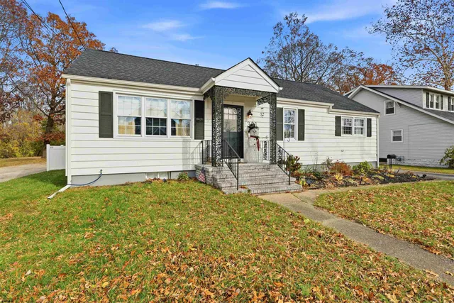 a front view of a house with a garden