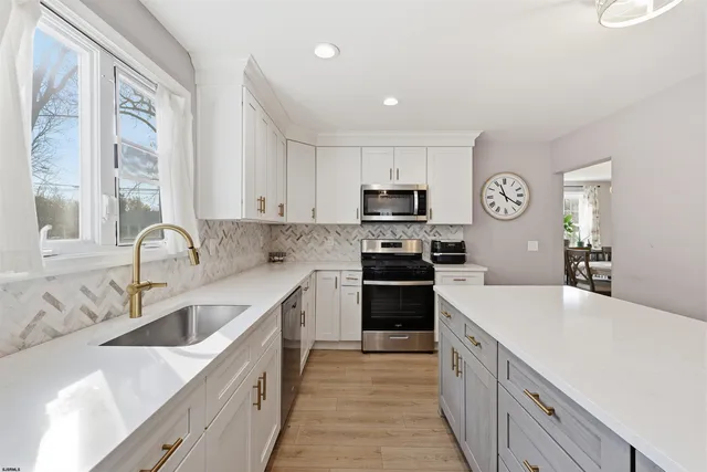 a kitchen with a sink stove top oven and refrigerator