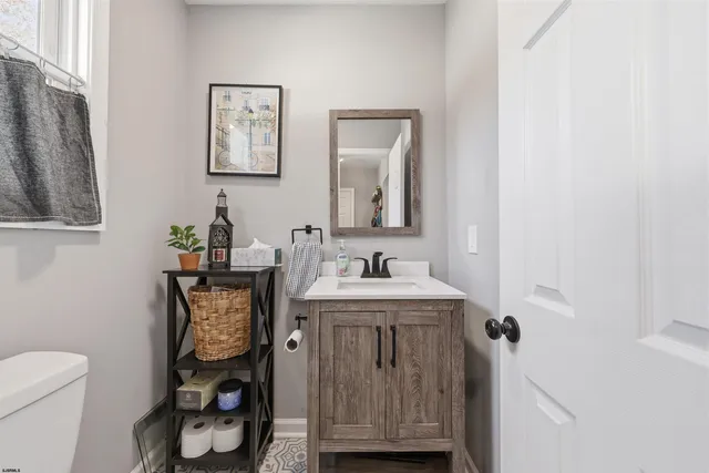 a bathroom with a toilet a sink and mirror