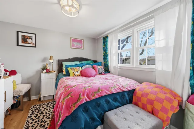 a bedroom with two beds and a window