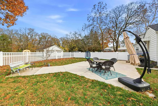 a swimming pool with outdoor seating and yard