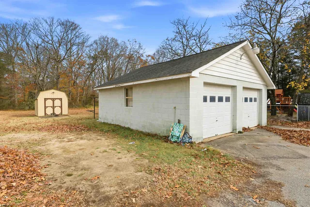 a view of a house with a yard and garage