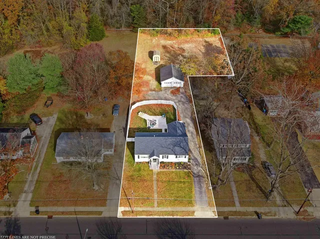 an aerial view of a residential houses with outdoor space
