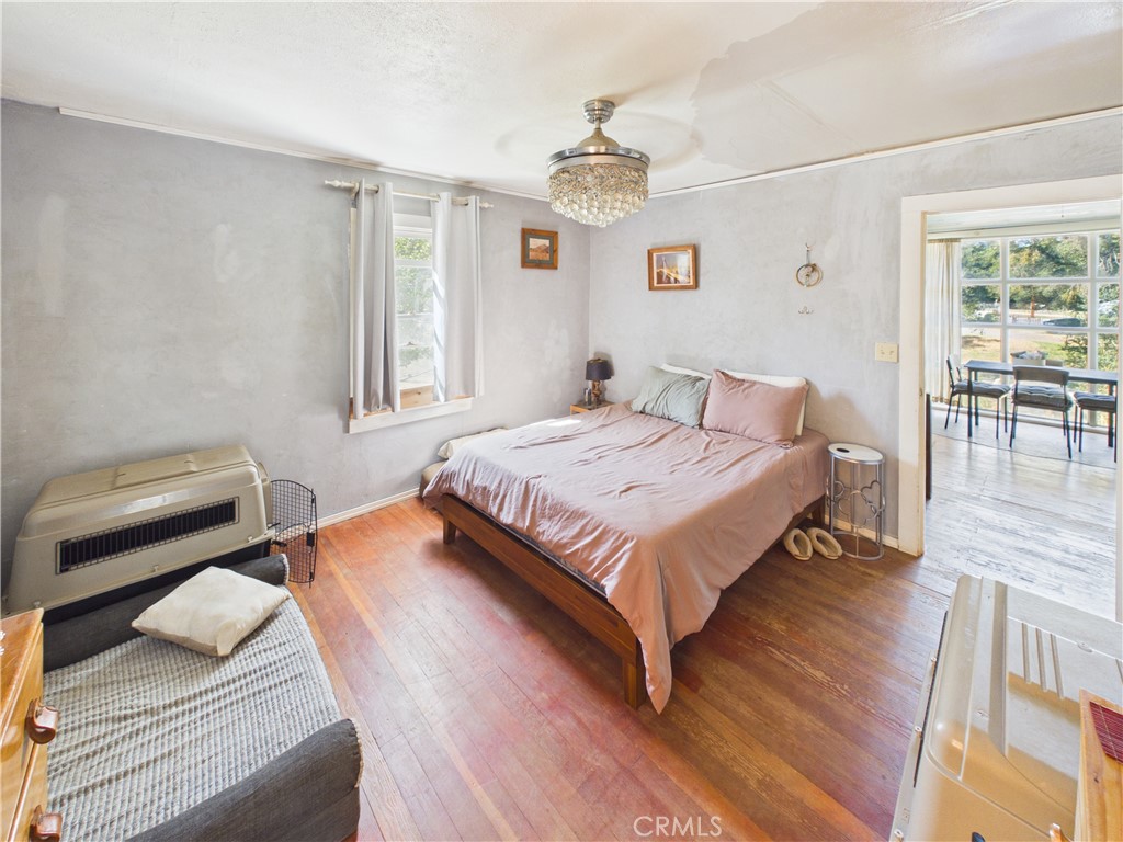 4208 Ramsden Road Mariposa, CA 95338 - Photo 17 of 42 a bedroom with a bed and wooden floor