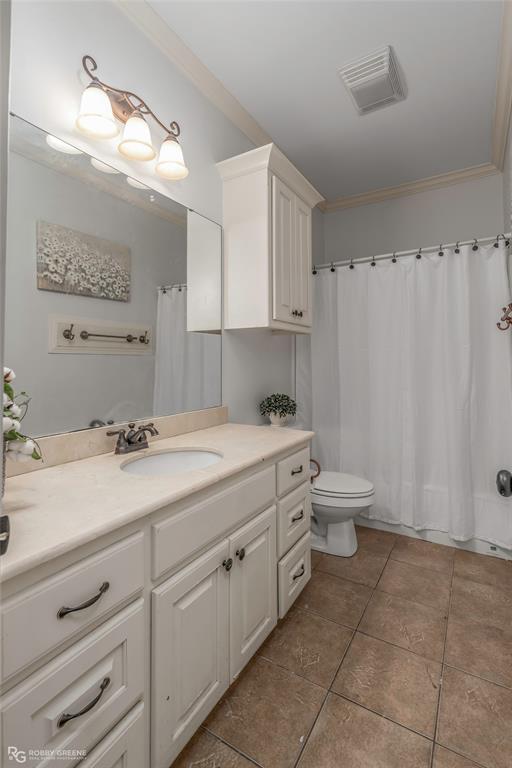 711 Reeds Reef Bossier City, LA 71112 - Photo 26 of 36 a bathroom with a double vanity sink a toilet and a mirror