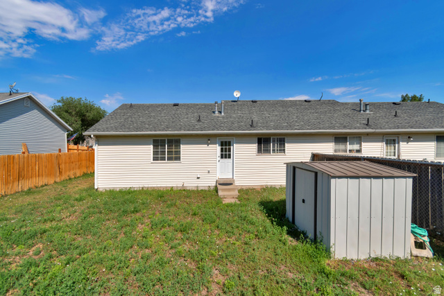 254 North 700 East Santaquin, UT 84655 - Photo 15 of 15 Rear exterior with siding, a shingle roof, multiple windows, and a white entry door