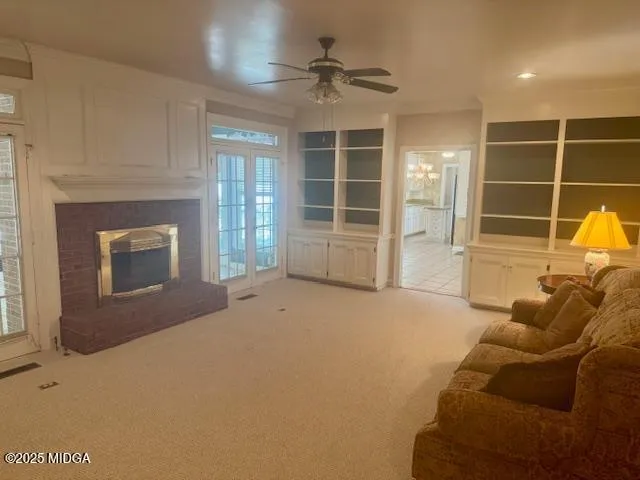 a living room with furniture a window and a fireplace