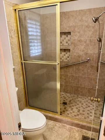 a bathroom with a toilet and shower