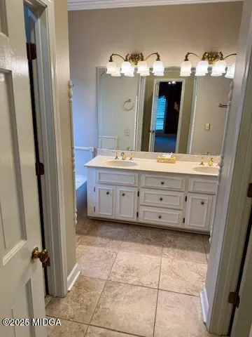 a bathroom with a double vanity sink mirror and toilet