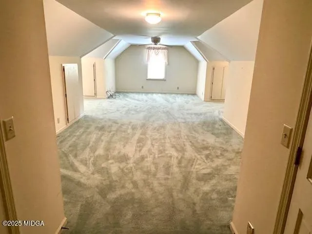 a view of a big room with wooden floor and windows
