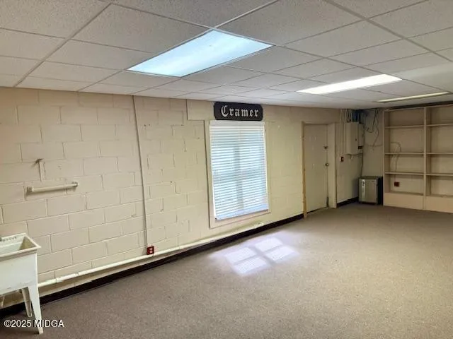 a view of a livingroom with an empty space and windows