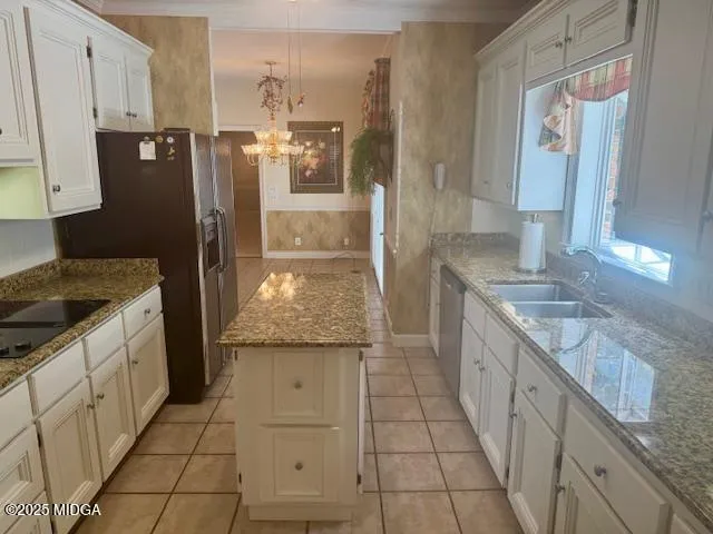a kitchen with stainless steel appliances granite countertop a refrigerator and a stove