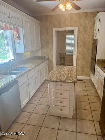 a kitchen with a wooden floor and cabinets