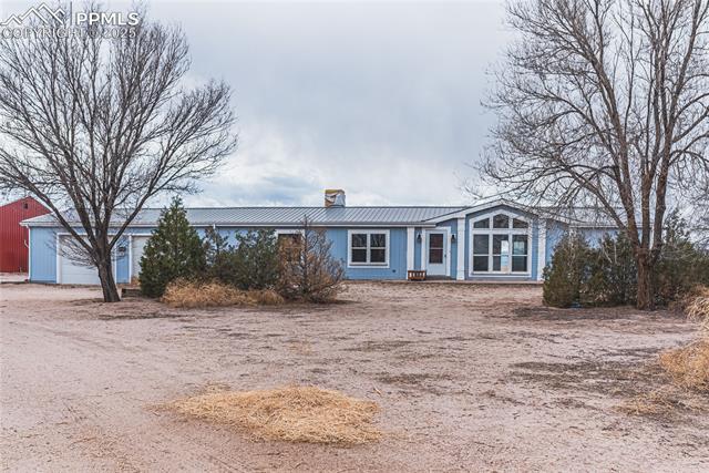22885 Handle Road Calhan, CO 80808 - Photo 2 of 38 View of front facade with a metal roof and a chimney
