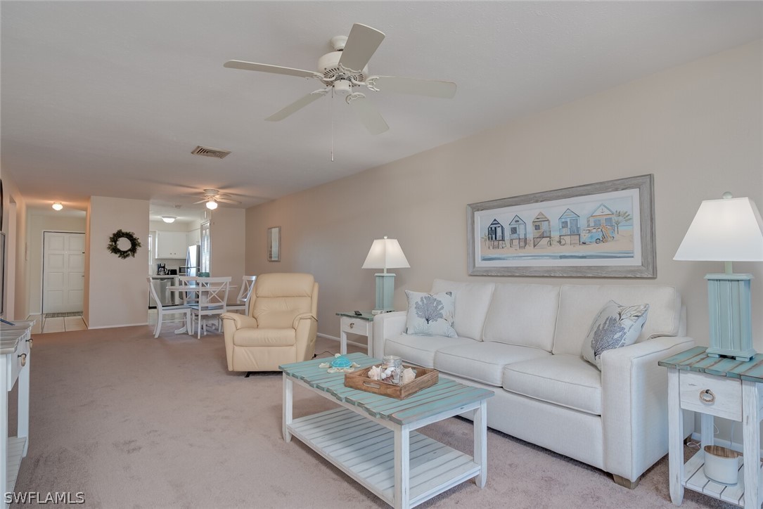 6777 Winkler Road, Unit 237 Fort Myers, FL 33919 - Photo 5 of 23 a living room with furniture and a chandelier